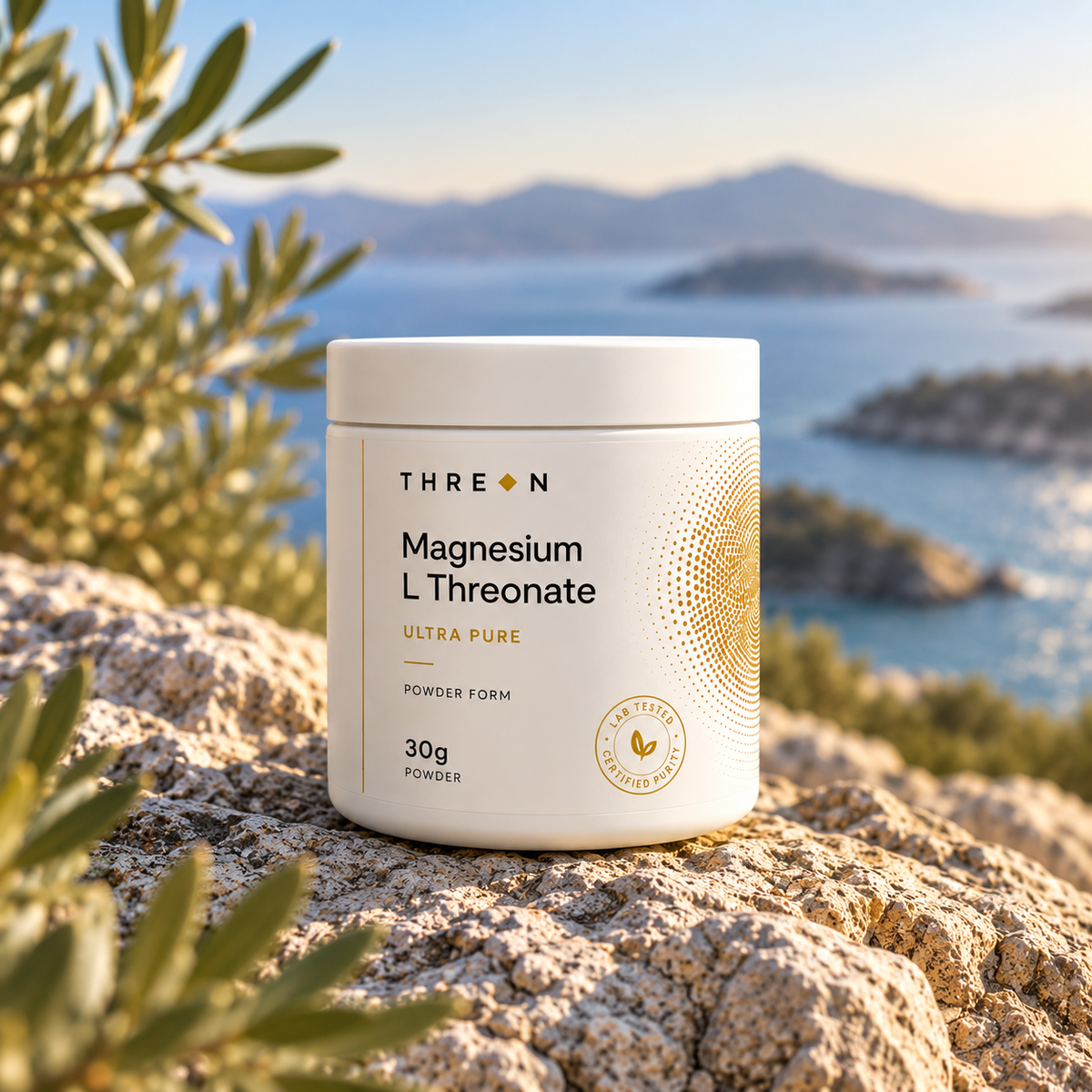 A white tub of Threon Magnesium L Threonate Ultra Pure powder sits on a rocky beach with sea and islands in the background, framed by green leaves in the foreground.