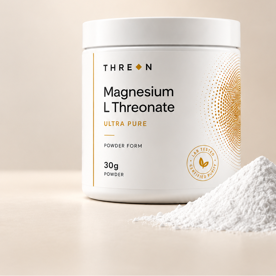 A white tub of THREON Magnesium L Threonate Ultra Pure powder with a small pile of white powder in the foreground, set against a warm beige background.